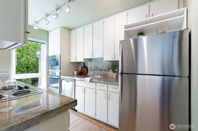 101 NW 58th St Unit 10, Seattle, WA 98107 - kitchen featuring appliances with stainless steel finishes, open shelves, white cabinets, backsplash, and track lighting