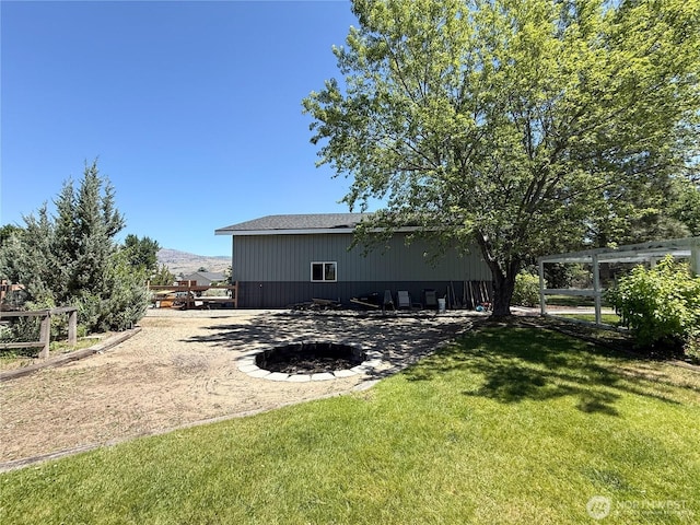 16 River Overlook St, Omak, WA 98841 - rear view of house with a yard, an outbuilding, and a pole building