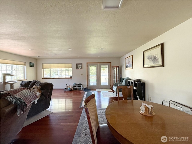 16 River Overlook St, Omak, WA 98841 - dining room featuring plenty of natural light, wood finished floors, french doors, and a textured ceiling