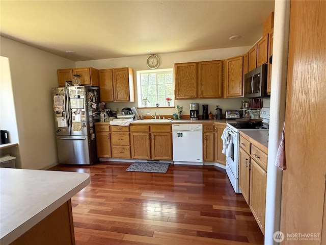 16 River Overlook St, Omak, WA 98841 - kitchen featuring stainless steel appliances, dark wood finished floors, light countertops, and brown cabinetry