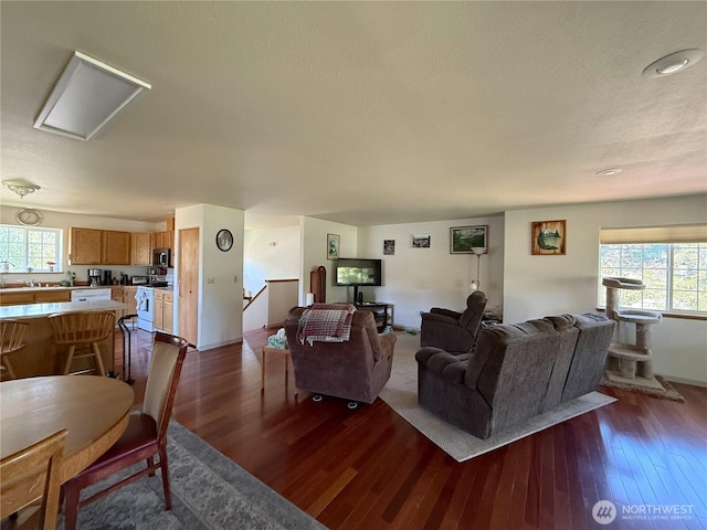 16 River Overlook St, Omak, WA 98841 - living room featuring healthy amount of natural light, dark wood-type flooring, and attic access