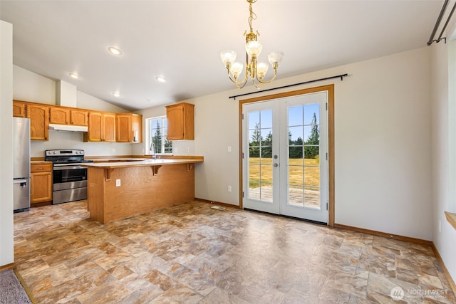 5436 180th Ave SW, Rochester, WA 98579 - kitchen featuring stainless steel appliances, stone finish flooring, a peninsula, a chandelier, and french doors