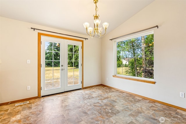 5436 180th Ave SW, Rochester, WA 98579 - spare room featuring stone finish floors, healthy amount of natural light, french doors, a chandelier, and vaulted ceiling