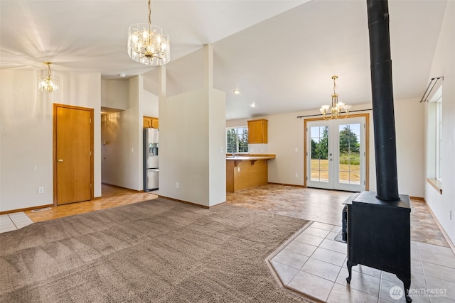 5436 180th Ave SW, Rochester, WA 98579 - unfurnished living room featuring a chandelier, vaulted ceiling, light tile patterned flooring, a wood stove, and recessed lighting