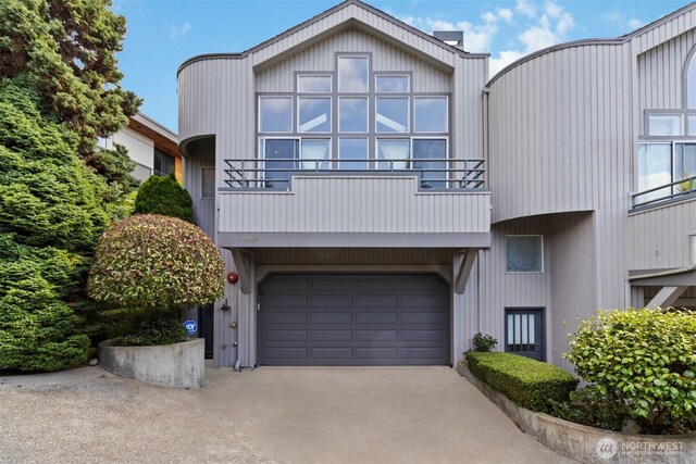 10135 NE 64th St Unit A, Kirkland, WA 98033 - view of front of home featuring driveway, an attached garage, and a balcony