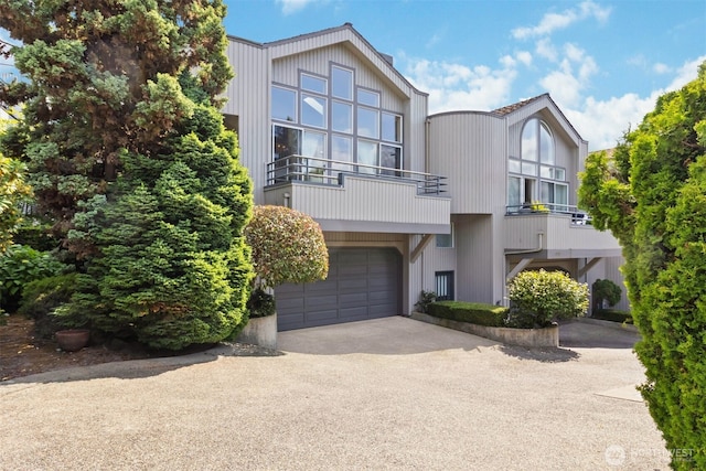 10135 NE 64th St Unit A, Kirkland, WA 98033 - view of front facade featuring asphalt driveway, an attached garage, and a balcony