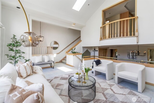 10135 NE 64th St Unit A, Kirkland, WA 98033 - carpeted living area featuring high vaulted ceiling, stairway, a skylight, and a chandelier