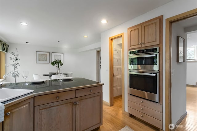 10135 NE 64th St Unit A, Kirkland, WA 98033 - kitchen with double oven, tile counters, light wood-style flooring, and recessed lighting