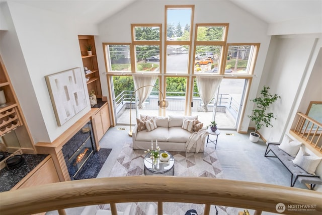 10135 NE 64th St Unit A, Kirkland, WA 98033 - living room with vaulted ceiling, a fireplace, and light colored carpet