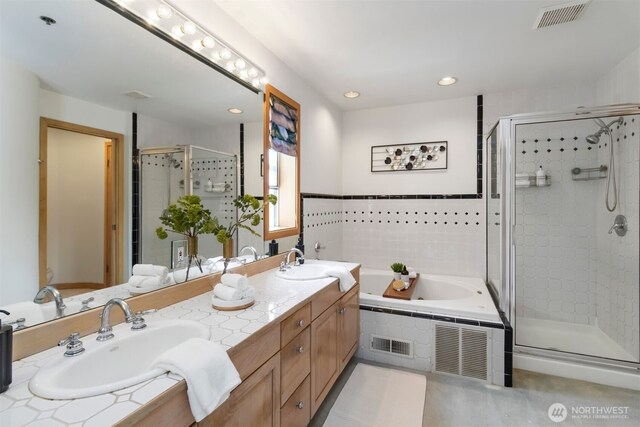 10135 NE 64th St Unit A, Kirkland, WA 98033 - full bathroom featuring double vanity, a shower stall, a garden tub, and recessed lighting