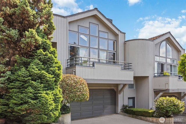 10135 NE 64th St Unit A, Kirkland, WA 98033 - view of front of home featuring concrete driveway, a garage, and a balcony