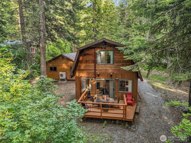 18690 Rieche Rd, Lake Wenatchee, WA 98826 - back of house with a wooden deck, a wooded view, and an outbuilding