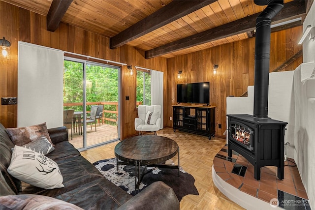 18690 Rieche Rd, Lake Wenatchee, WA 98826 - living area featuring wooden walls, a wood stove, and a wood ceiling with exposed beams