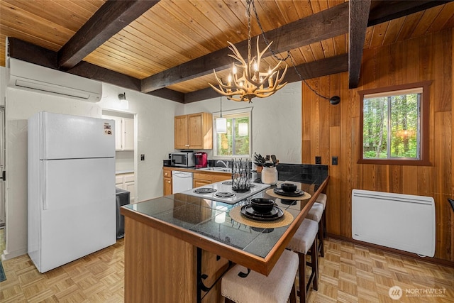 18690 Rieche Rd, Lake Wenatchee, WA 98826 - kitchen with white appliances, a wood ceiling with exposed beams, a wall unit AC, wood walls, and a chandelier