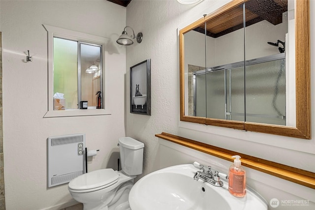 18690 Rieche Rd, Lake Wenatchee, WA 98826 - full bath with heating unit, a textured wall, and an enclosed shower
