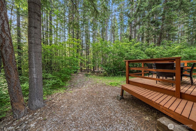 18690 Rieche Rd, Lake Wenatchee, WA 98826 - view of yard featuring a deck and a wooded view