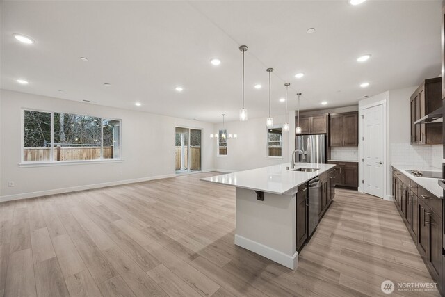 20424 E 97th Ave E Unit 6, Graham, WA 98338 - kitchen featuring stainless steel appliances, light wood-type flooring, dark brown cabinetry, light countertops, and recessed lighting