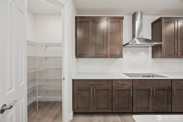 20424 E 97th Ave E Unit 6, Graham, WA 98338 - kitchen with wall chimney exhaust hood, black electric cooktop, light wood-type flooring, light countertops, and dark brown cabinets