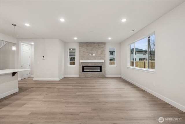 20424 E 97th Ave E Unit 6, Graham, WA 98338 - unfurnished living room with light wood-style flooring, recessed lighting, and a fireplace