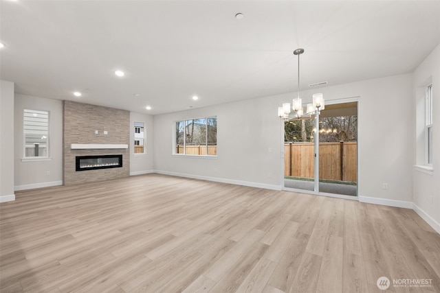 20424 E 97th Ave E Unit 6, Graham, WA 98338 - unfurnished living room featuring a chandelier, light wood-style floors, recessed lighting, and a fireplace