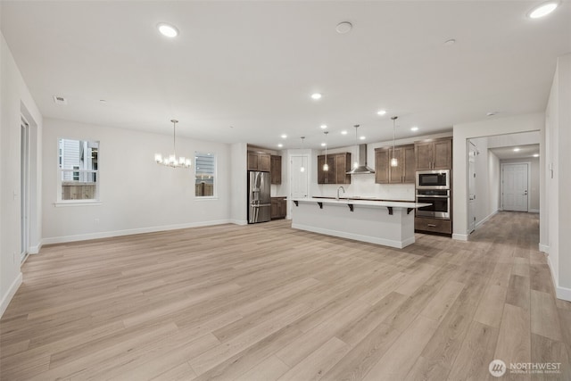20424 E 97th Ave E Unit 6, Graham, WA 98338 - unfurnished living room featuring recessed lighting, light wood-style flooring, and a chandelier