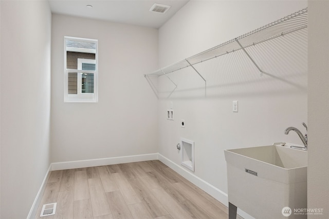 20424 E 97th Ave E Unit 6, Graham, WA 98338 - laundry room with hookup for an electric dryer, light wood finished floors, and washer hookup