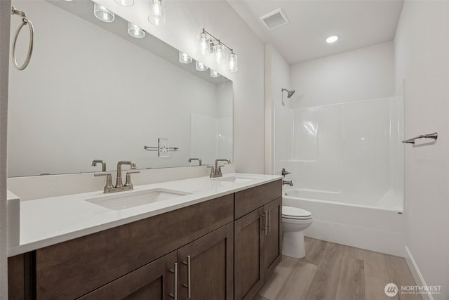 20424 E 97th Ave E Unit 6, Graham, WA 98338 - bathroom with double vanity, bathing tub / shower combination, wood finished floors, and recessed lighting