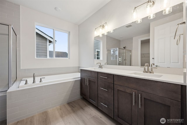 20424 E 97th Ave E Unit 6, Graham, WA 98338 - full bathroom with a shower stall, double vanity, wood finished floors, a garden tub, and a walk in closet