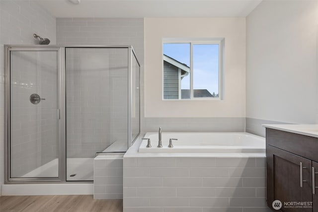 20424 E 97th Ave E Unit 6, Graham, WA 98338 - full bathroom with a bath, a stall shower, vanity, and wood finished floors