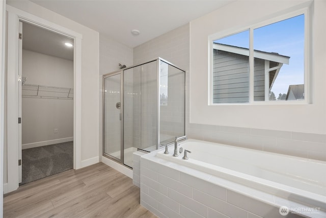 20424 E 97th Ave E Unit 6, Graham, WA 98338 - full bath with a shower stall, a bath, a walk in closet, and wood finished floors