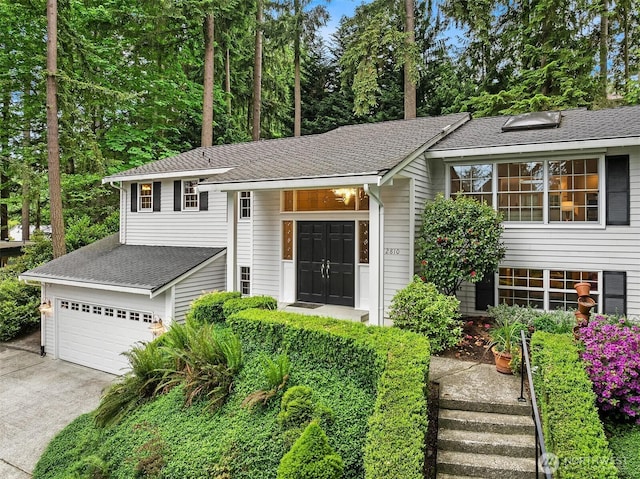 12810 NE 32nd Pl, Bellevue, WA 98005 - view of front of home featuring a garage, concrete driveway, and roof with shingles