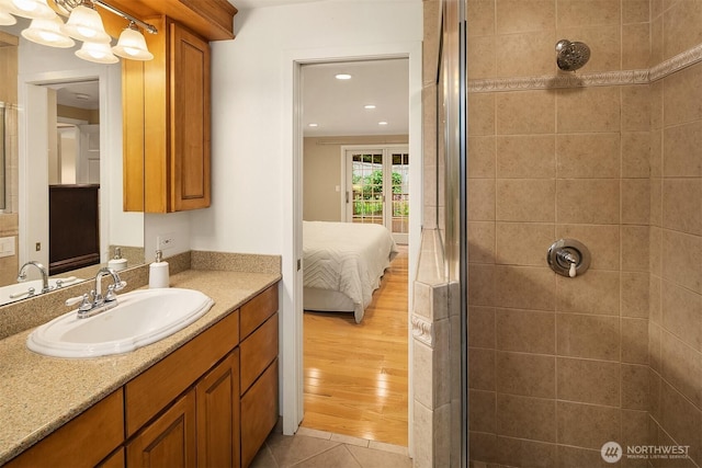 12810 NE 32nd Pl, Bellevue, WA 98005 - full bathroom featuring a tile shower, vanity, recessed lighting, connected bathroom, and tile patterned floors