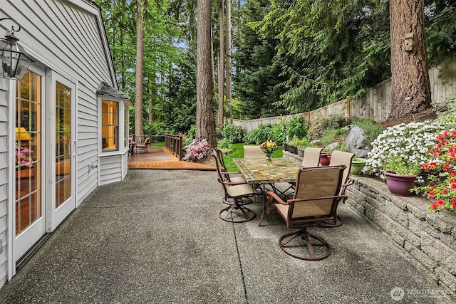 12810 NE 32nd Pl, Bellevue, WA 98005 - fenced backyard with outdoor dining area, a wooden deck, and a patio area