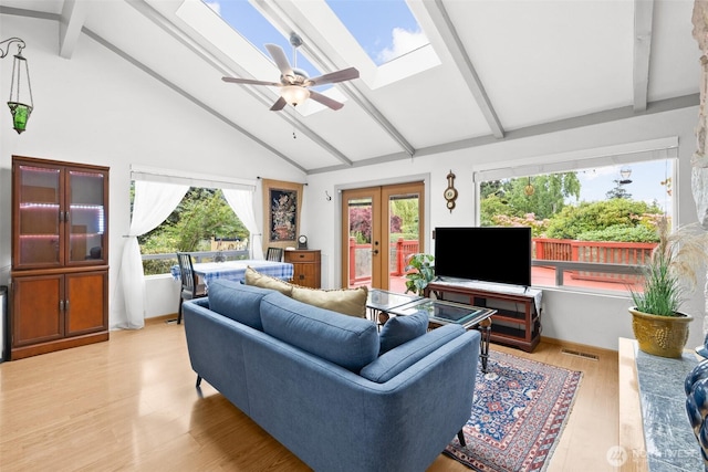 50 Hemlock Way, Sequim, WA 98382 - living room with beam ceiling, french doors, a skylight, a ceiling fan, and light wood-style floors