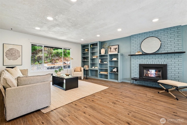 933 N Stephenson, Montesano, WA 98563 - living room featuring wood finished floors, a textured ceiling, recessed lighting, and a fireplace