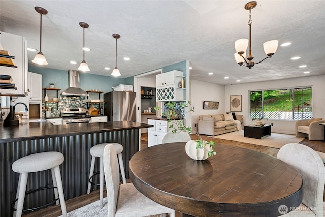 933 N Stephenson, Montesano, WA 98563 - dining room featuring wood finished floors, a chandelier, recessed lighting, and a textured ceiling