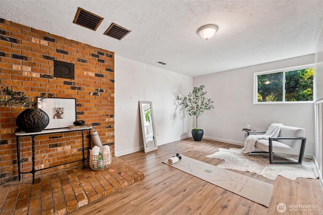 933 N Stephenson, Montesano, WA 98563 - workout area featuring a textured ceiling and wood finished floors
