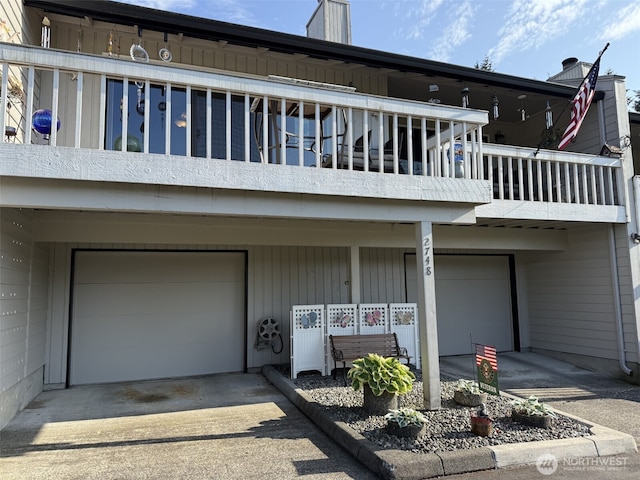 2748 SW 327th St S, Federal Way, WA 98023 - back of house with a balcony, an attached garage, and driveway