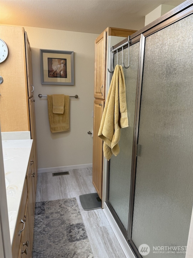 2748 SW 327th St S, Federal Way, WA 98023 - full bath with wood finished floors, vanity, and a stall shower