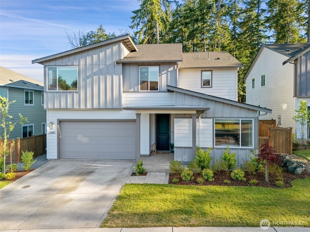 2405 NE Waterlily Way, Poulsbo, WA 98370 - view of front of house featuring board and batten siding, a garage, driveway, and a shingled roof