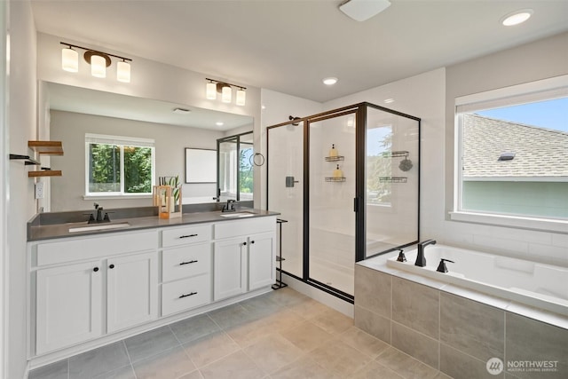 2405 NE Waterlily Way, Poulsbo, WA 98370 - bathroom featuring a shower stall, double vanity, a garden tub, tile patterned floors, and recessed lighting