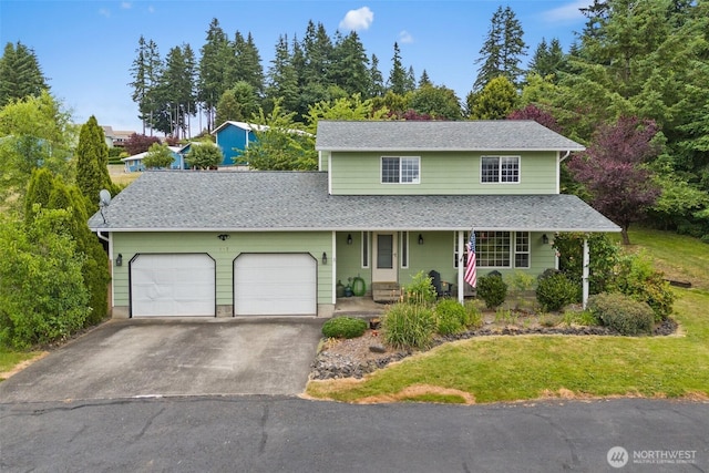 127 Springbrook Dr, Chehalis, WA 98532 - traditional home with a garage, driveway, a shingled roof, a front yard, and a porch
