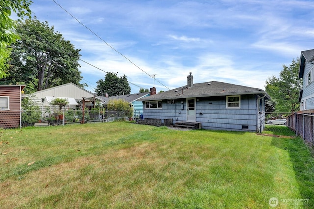 4723 50th Ave SW, Seattle, WA 98116 - rear view of house featuring a chimney and a fenced backyard