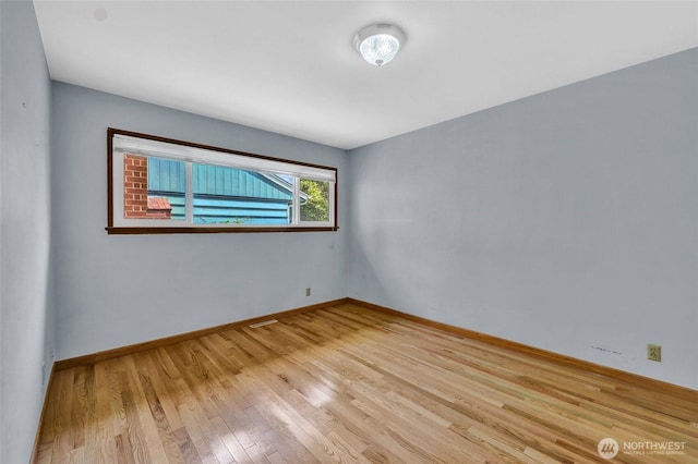 4723 50th Ave SW, Seattle, WA 98116 - empty room with wood finished floors and baseboards