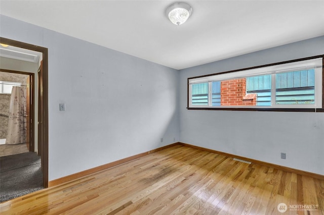 4723 50th Ave SW, Seattle, WA 98116 - empty room with wood finished floors and baseboards