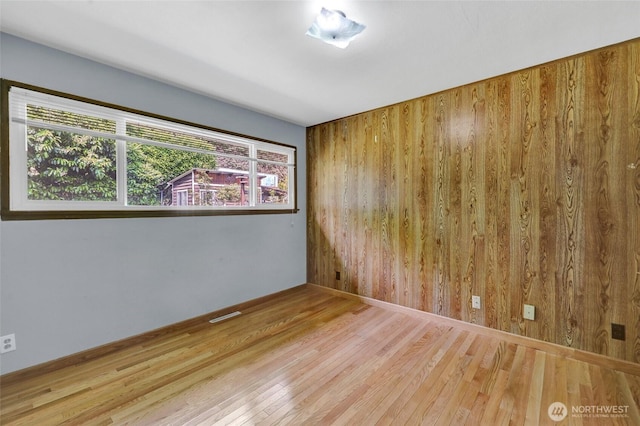 4723 50th Ave SW, Seattle, WA 98116 - unfurnished room with wood finished floors and wood walls