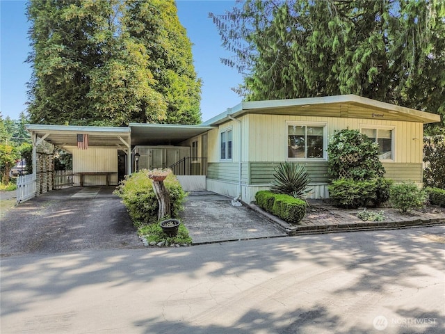 900 29th St SE Unit E-22, Auburn, WA 98002 - manufactured / mobile home featuring driveway and a carport