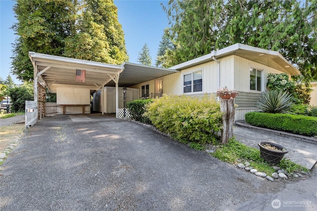 900 29th St SE Unit E-22, Auburn, WA 98002 - manufactured / mobile home featuring asphalt driveway and an attached carport
