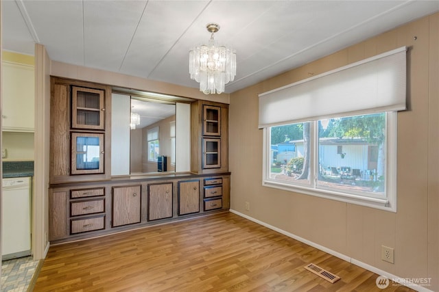 900 29th St SE Unit E-22, Auburn, WA 98002 - unfurnished dining area with a chandelier and light wood finished floors