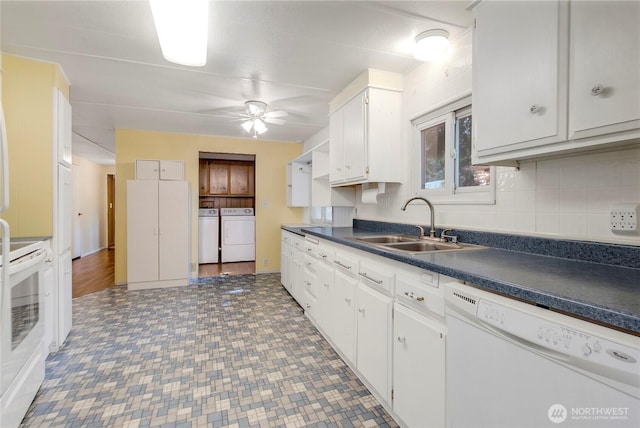 900 29th St SE Unit E-22, Auburn, WA 98002 - kitchen with white appliances, washing machine and dryer, dark countertops, a ceiling fan, and white cabinetry